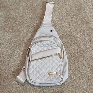 Beige quilted sling bag with adjustable strap